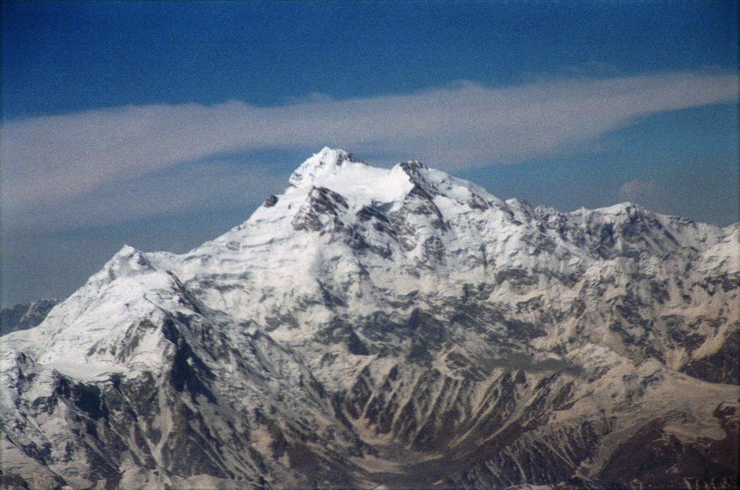 10 Nanga Parbat Rakhiot Face, Rakhiot Peak, Silver Saddle, East Peak, Silver Plateau, Summit, North Peaks On Flight From Islamabad To Skardu The flight from Islamabad to Skardu continues to fly around Nanga Parbat with Hermann Buhls route of first ascent becoming perfectly visible. Rakhiot Peak leads up to the Silver Saddle between the Nanga Parbat Southeast and East Peaks, and up to the summit with the North Peaks on the right.